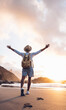 © Davide Angelini - Happy traveler with hands up standing at the beach - Delightful man enjoying success and freedom outdoors - Wanderlust, wellbeing, travel and summertime holidays concept