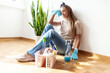 © Jelena Stanojkovic - Tired, sad and woman cleaning home overwhelmed, stressed and moody thinking of tasks. Spring cleaning fatigue of young girl thoughtful in house living room with cleaner hygiene products.