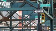 © Dogora Sun - New York elevated subway, metropolitan bridge, metro track above street. Railway transport over road. Railroad line. Queens public transportation. Long Island city, United States. Yellow traffic light