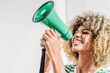 © VISTA by Westend61 - Woman with curly hair screaming through megaphone