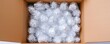 © Gencraffic - A cardboard box filled with bubble-wrapped items, showcasing a safe and secure packing method for sensitive materials.