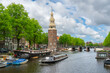 © robertharding - Boat on Rapenburgwal canal and Montelbaanstoren tower in the background, Amsterdam, The Netherlands, Europe