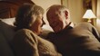 © sirisakboakaew - Elderly couple in bed, smiling warmly, looking at each other with love