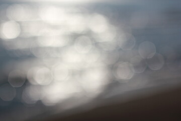 Wall Mural - a blurry dreamy view of waves lapping on the beach.