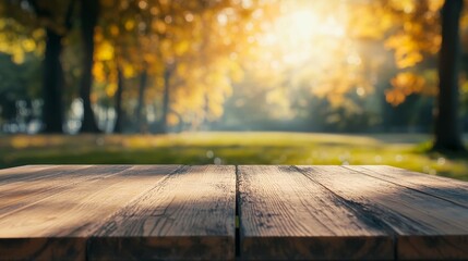 Exuberant image of an empty wooden table top made of old oak planks with a blurred background of autumn park.