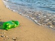© RooM The Agency - Close-up of a discarded Green plastic bottle washed up on a beach, Skala, Agistri, Saronic Islands, Greece