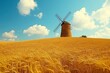 © ardanz - Windmill in a golden wheat field under a blue sky.