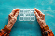 © Marta - Hand of senior person taking pills from a pillbox isolated on blue