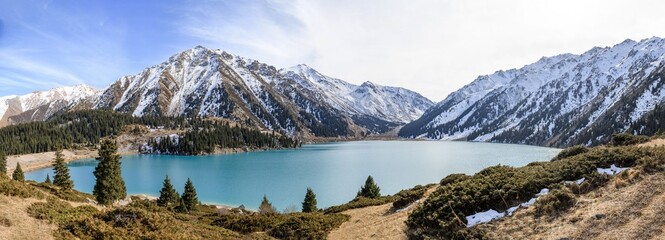 Wall Mural - Beautiful mountain lake with ice and snow. Big Almaty lake in winter time. Kazakhstan.