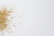 © VERTEX SPACE - Golden glitter scattered on light background creates festive and magical atmosphere, perfect for celebrations and artistic projects. shimmering particles add touch of elegance and charm