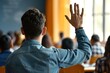 © Rawpixel.com - Back view of older student raising his hand architecture classroom education.