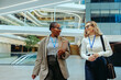 © Jacob Lund - Successful young accountants walking and talking in a modern office environment