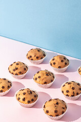 Fresh baked and tasty chocolate chips muffins on color background