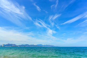 Wall Mural - View of an open trophic bay with a beautiful view of the sky with cirrus clouds and on the horizon hills landscape and buildings of the city