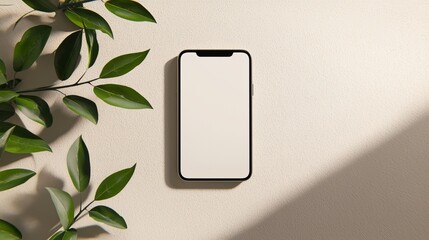 Poster - Mobile Phone With Blank Screen Mockup On Natural Beige Stone Background With Green Leaves, Top View