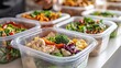 © PixelNexusArt - Meal prep containers filled with healthy salads and ingredients.