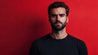 © Mirjana - Man poses confidently in front of a bold red backdrop, showcasing a serious expression and contemporary style for a striking visual impact