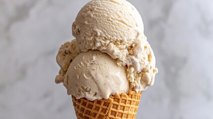 Vanilla ice cream in a waffle cone, showcasing the creamy texture against a minimalist background