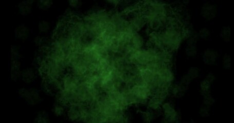Wall Mural - green smoke explosion slowly floating through space against black background