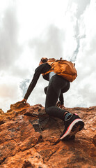 successful female hiker climbing mountains - sport life style concept - vertical photo