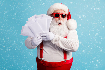 Wall Mural - portrait of his he nice attractive amazed wondered overwhelmed thick white-haired santa holding in h