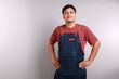 © ArvStd - Small business shop owner. Apron man smiling proud and happy isolated on white background. Young entrepreneur or shop assistant. Young asian male model.