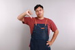 © ArvStd - Moody unsatisfied asian man wearing blue apron, disliking bad restaurant food smirking displeased, grimacing disappointed show thumb down, shaking head negative judgement, stand white background