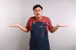 © ArvStd - Photo image of funny Asian man in apron with shrug shoulder up gesture, showing i don't know or rejection
