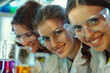 © Alberto Gonzalez  - Three female scientists analyzing chemical samples in laboratory glassware.