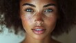 © AdorStudios - soft and glowing skin of a biracial model, freckled face with smooth texture, delicate and elegant features, closeup portrait with warm lighting, youthful and confident expression, radiant and flawles