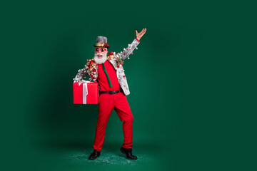 Full size photo of isolated on excited grandfather gift festive ornament outfit red pants empty space dark green color background