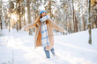 © maxbelchenko - Happy woman laughing and enjoying a snowy winter day in the forest. Fashion style. Winter holidays.