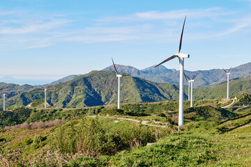 Green energy concept. Mountain top industrial wind power plant, wind turbines for generation electricity in wind farm or wind park.