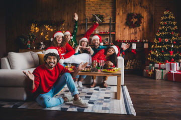 Full size photo of nice young people have fun cheerful enjoy cozy christmas decoration interior house indoors party