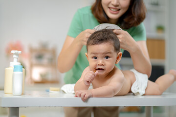 Asian baby and woman doing lifestyle activities together at home.