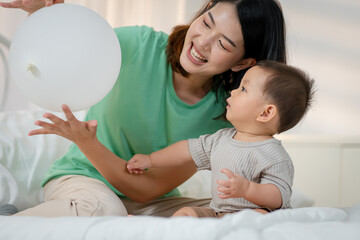 Asian baby and woman doing lifestyle activities together at home.