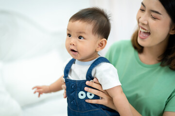 Asian baby and woman doing lifestyle activities together at home.