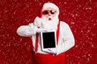 © deagreez - Portrait of his he attractive amazed stunned fat white-haired Santa holding in hands ebook gadget pout lips sale isolated bright vivid shine vibrant red burgundy maroon color background