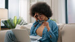 © Yuliia - African American woman sad girl frustrated with insufficient funds problems payment online credit bank card trouble failure internet shopping bankruptcy use laptop try pay blocked scam fraud at home