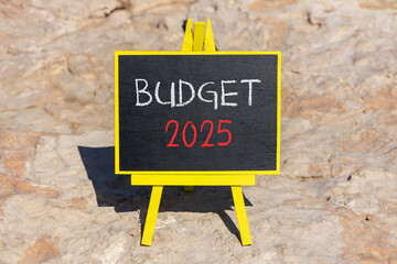 Planning budget 2025 new year symbol. Concept words Budget 2025 on beautiful yellow chalk blackboard. Beautiful stone beach background. Business budget 2025 new year concept. Copy space.