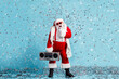© deagreez - Full length photo of retired grandfather grey beard sing modern x-mas carol mic confetti hold retro radio wear santa costume suspender sunglass cap boots isolated blue color background
