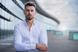 © Scopio - Caucasian male in white formal button shirt standing with folded arms