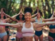 © bvbflo1 - Group of multiethnic women stretching arms outdoor.Yoga