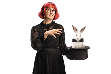 Female magician with a top hat performing a magic trick with a bunny