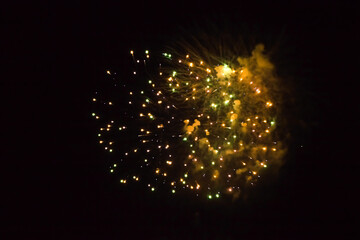 Wall Mural - yellow fireworks closeup in black background