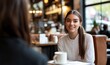 © Valentyna - Happy businesswoman looking at colleague sitting in cafe