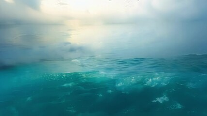 Wall Mural - surreal imagery showcases an ocean transitioning from above the surface to below, featuring clouds r