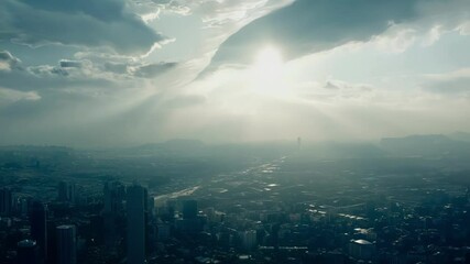 Wall Mural - surreal sunlight breaks through a cloudy sky, illuminating a vast cityscape. the scene captures the 