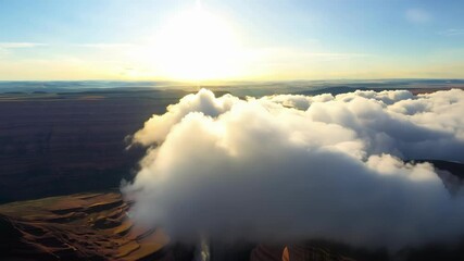 Wall Mural - surreal white clouds grow and drift over horseshoe bend during a stunning sunset, creating a dramati