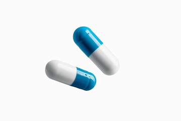 White and blue medicine capsule tablet float on white background